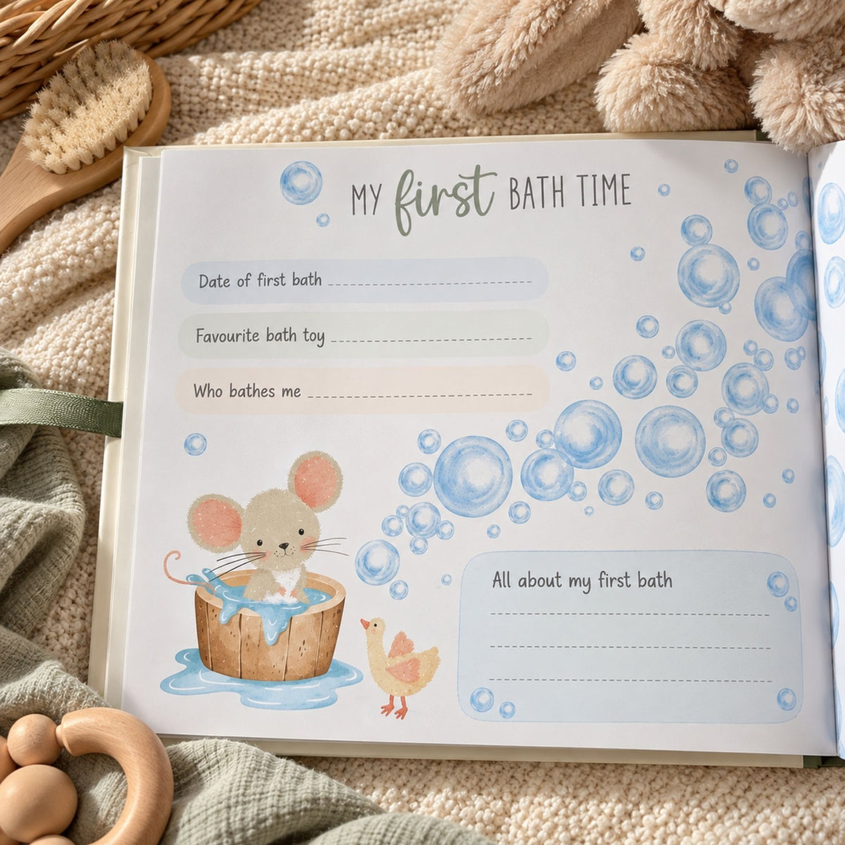An open baby keepsake journal or photo album page titled 'My first BATH TIME' with lined spaces for writing