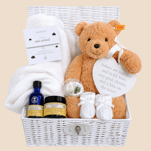 Luxury baby gifts hamper with a steiff teddy bear and white cellular baby blanket in a basket