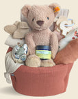 New baby hamper with teddy bear and organic clothing and blanket.