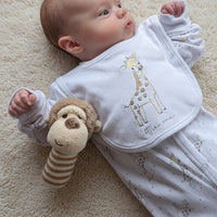 Monkey stick rattle next to a baby