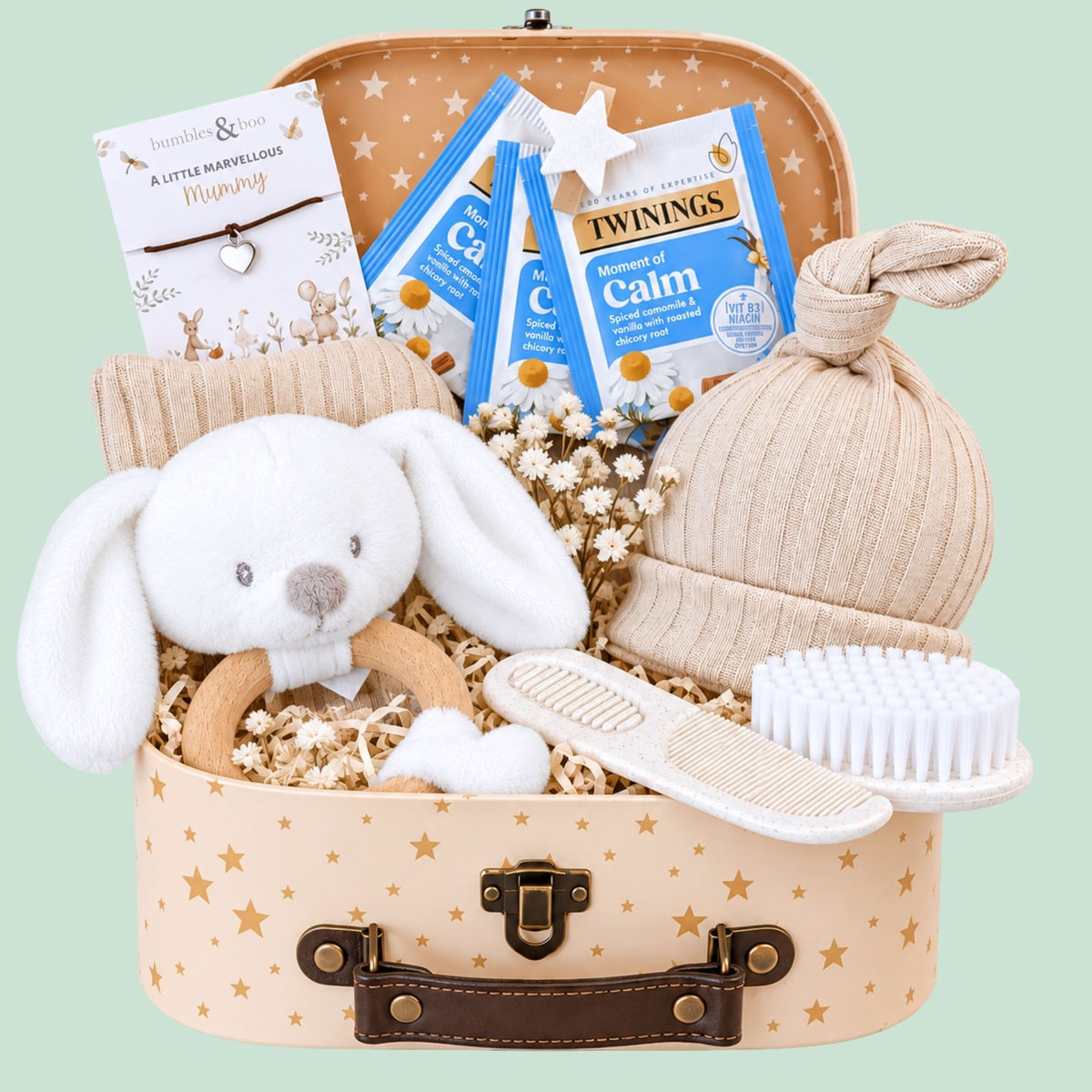 Mum to be gifts hamper with presents including wish string bracelet and baby essentials in a floral gift box by Bumbles and Boo.