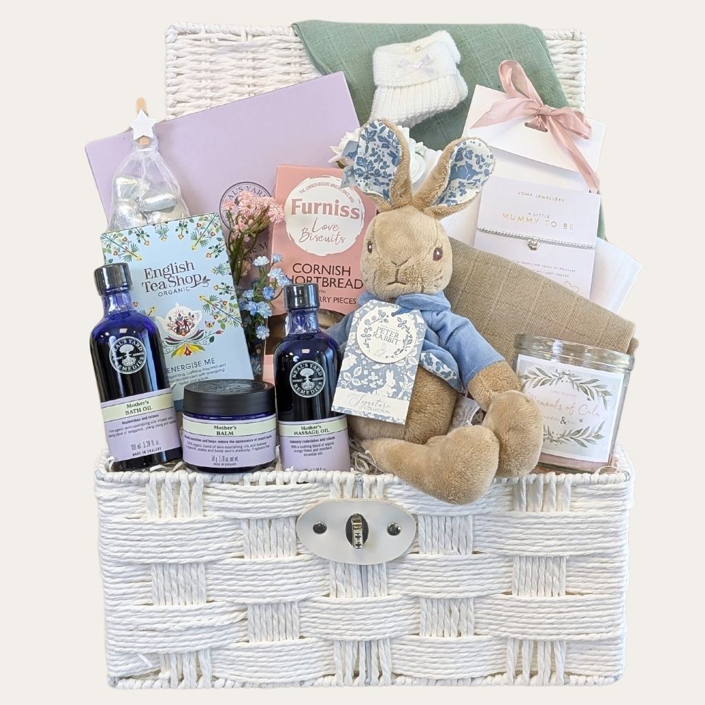 Mum to be gifts presented in a white hamper. Filled with organic pregnancy skincare and delicious presents. Bumbles and Boo. 