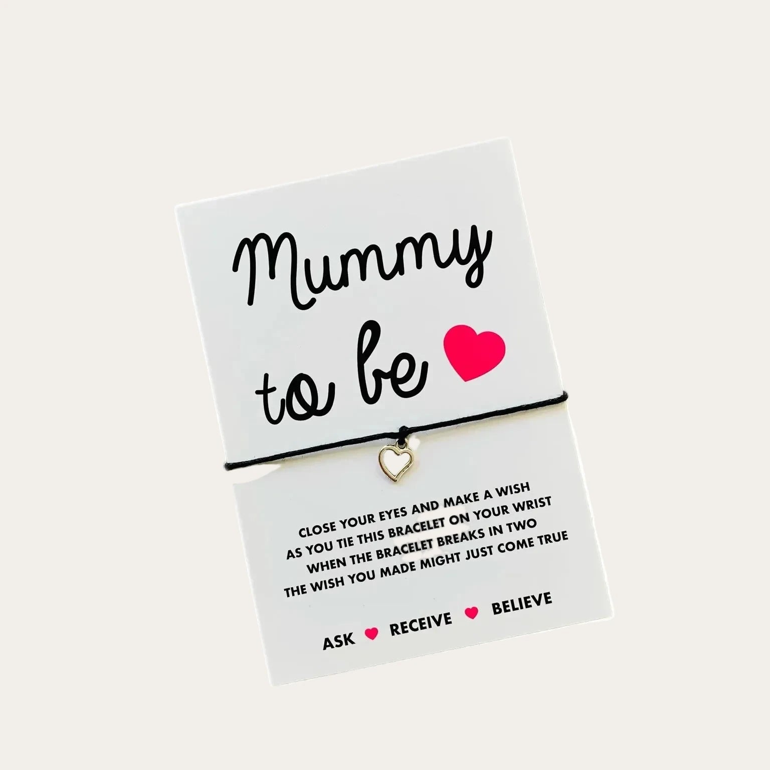 Mummy to be wish string bracelet displayed on a card with heart charm and black cord.