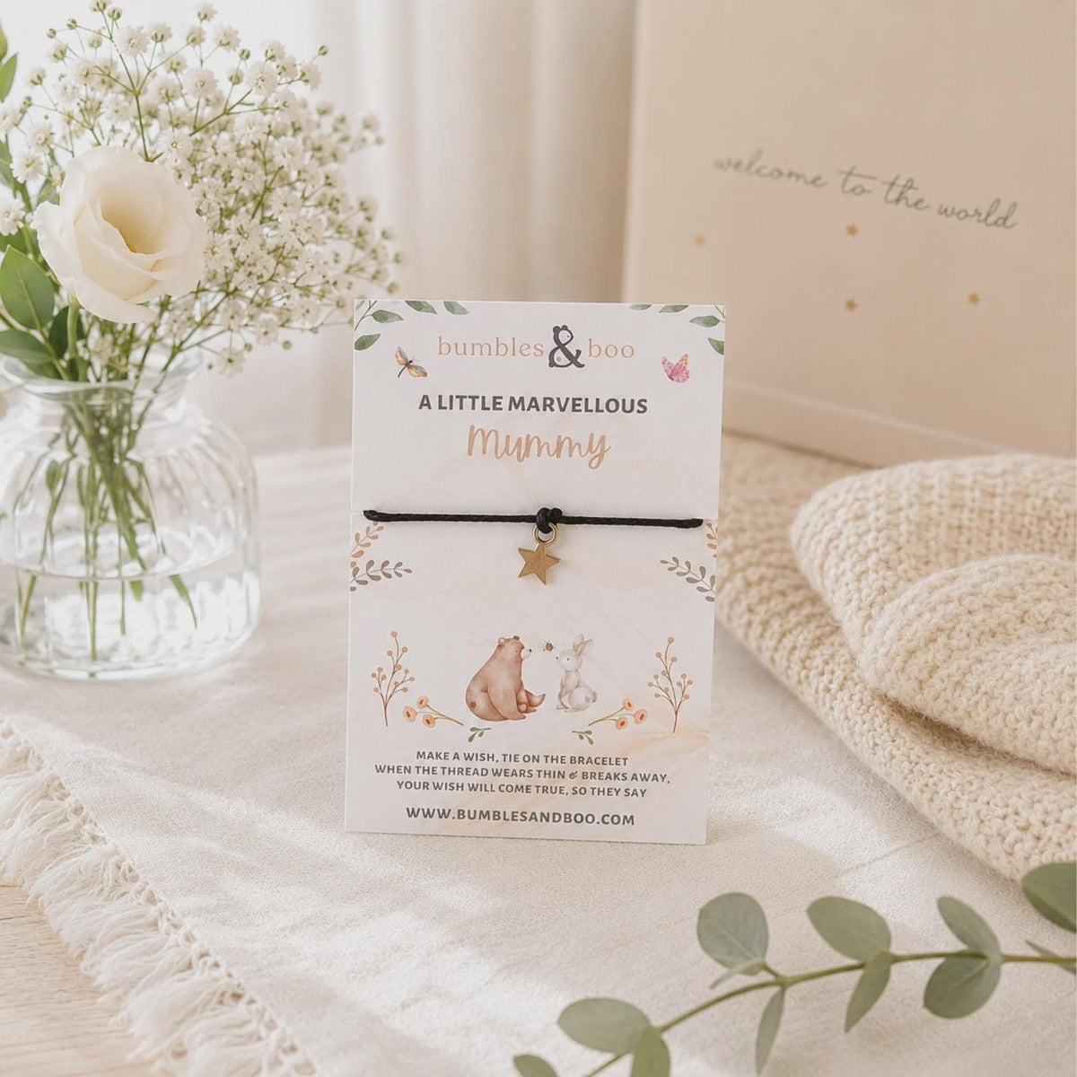 Mummy wish bracelet with a star charm and black cord displayed on a Marvellous Mummy card