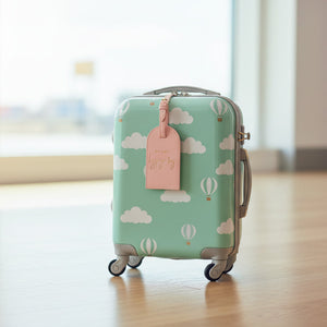 Close up of pink vegan leather My First Luggage Tag with gold buckle and stitched edge, stylish travel accessory.