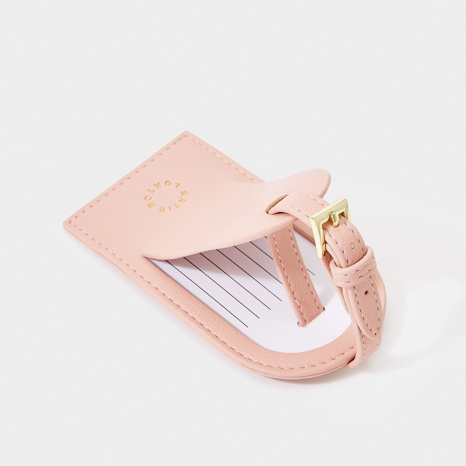 Pink My First Luggage Tag in vegan leather with gold lettering attached to suitcase, travel accessory from new mum gifts collection.