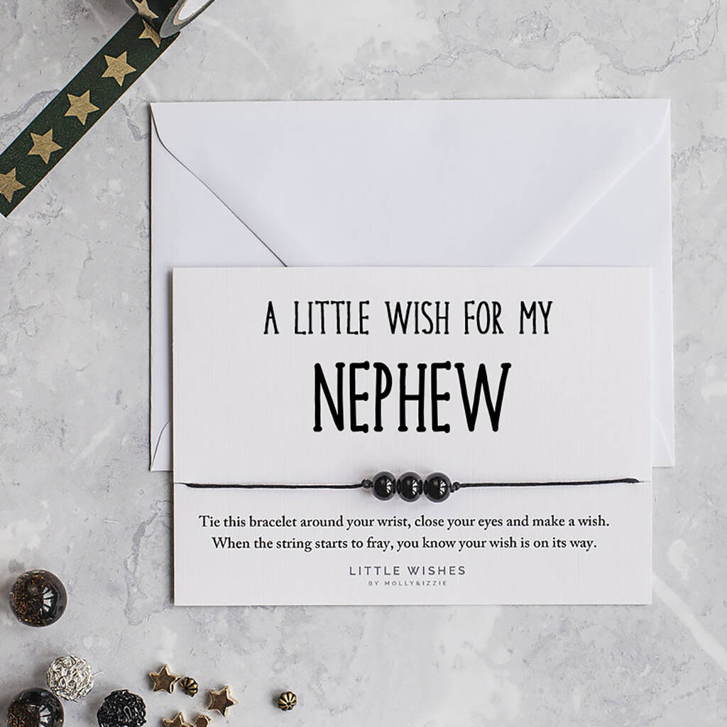 Black cord bracelet with three black beads on an A Little Wish for My Nephew card beside a white envelope