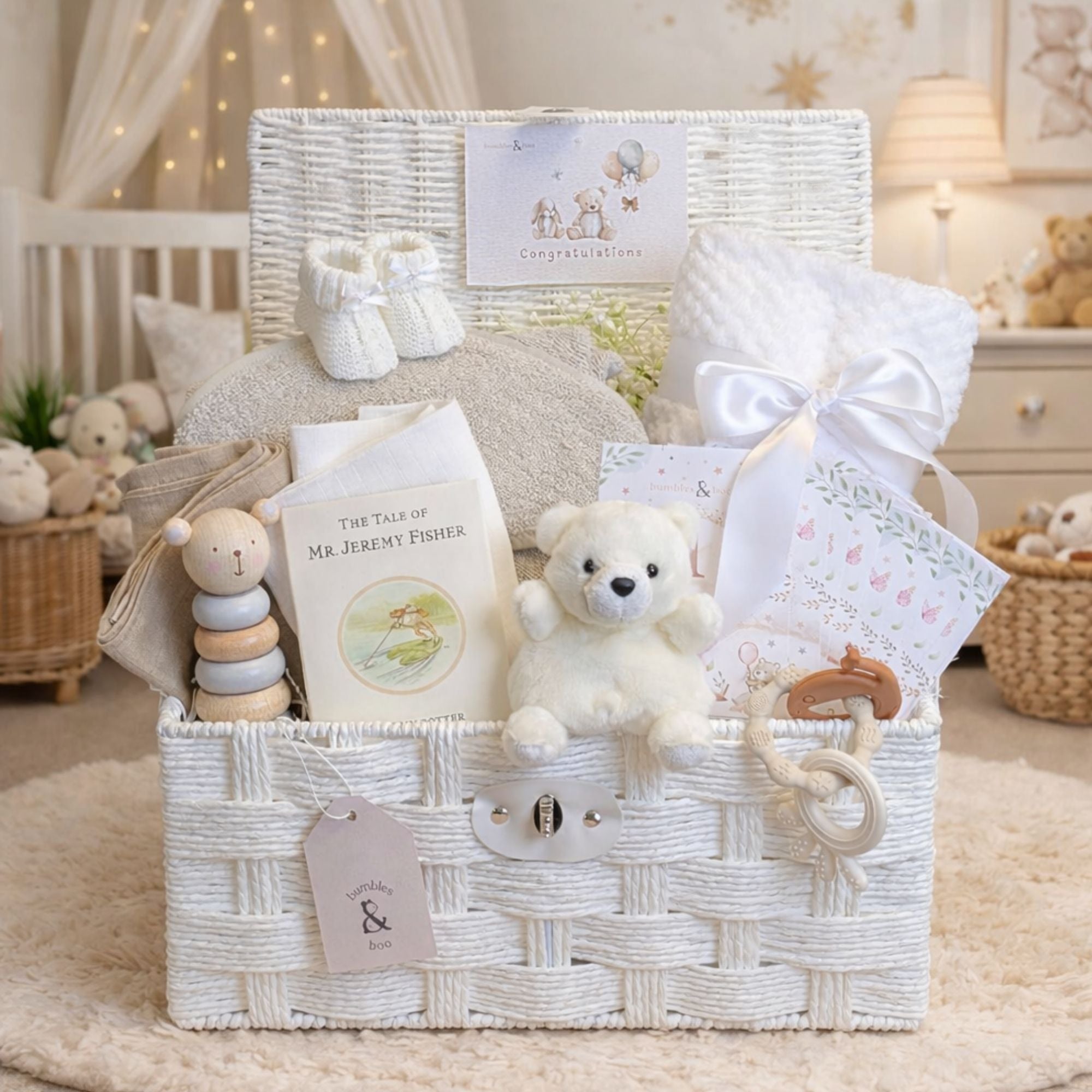 Neutral baby gifts in a hamper with blanket and teddy bear in soft beige and white colours.