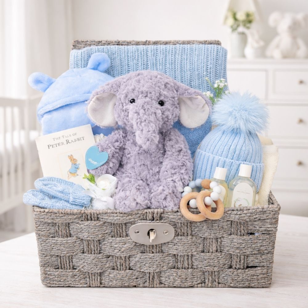 A blue and grey gifts for a new baby boy with a blanket set and elephant cuddly toy.