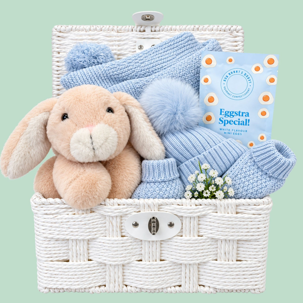 Newborn baby boy hamper basket with gifts including bunny soft toy and baby blue blanket and baby accessories 