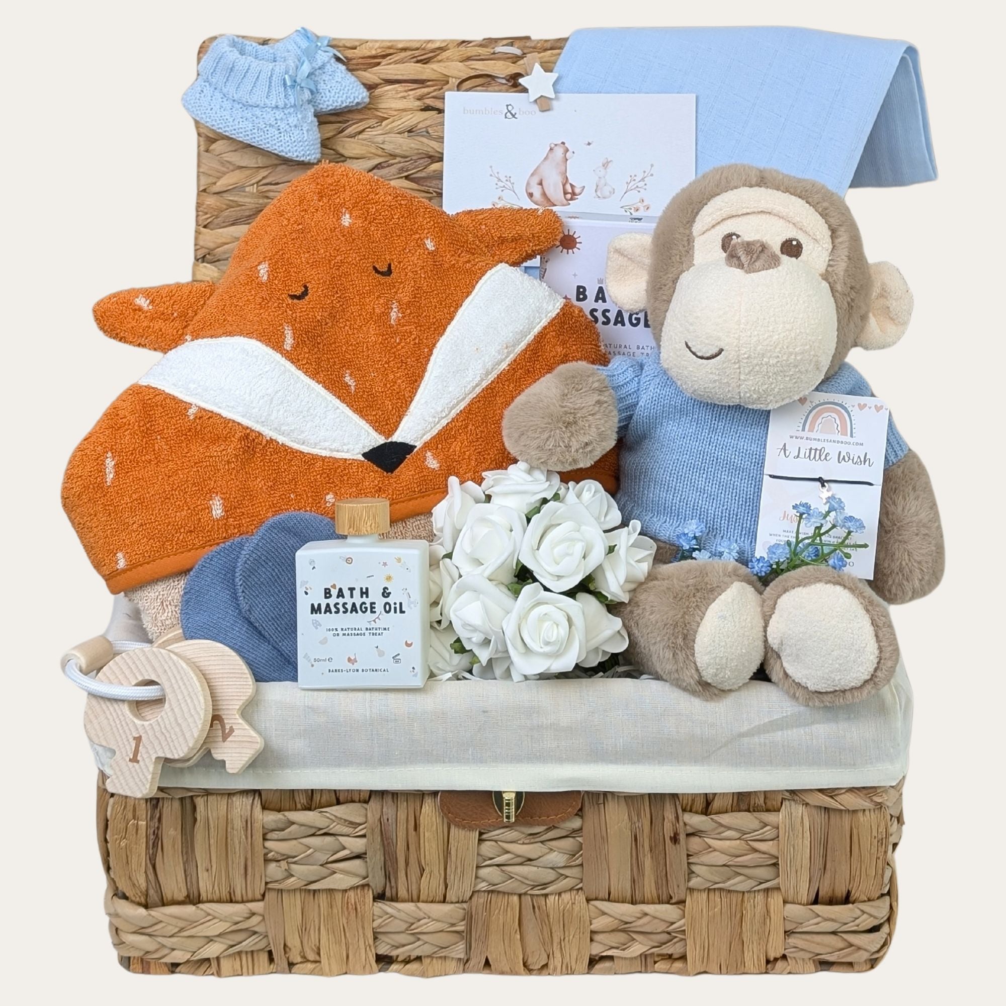 New baby boy gifts basket. Presents in this hamper include monkey soft toy and orange fox hooded towel.