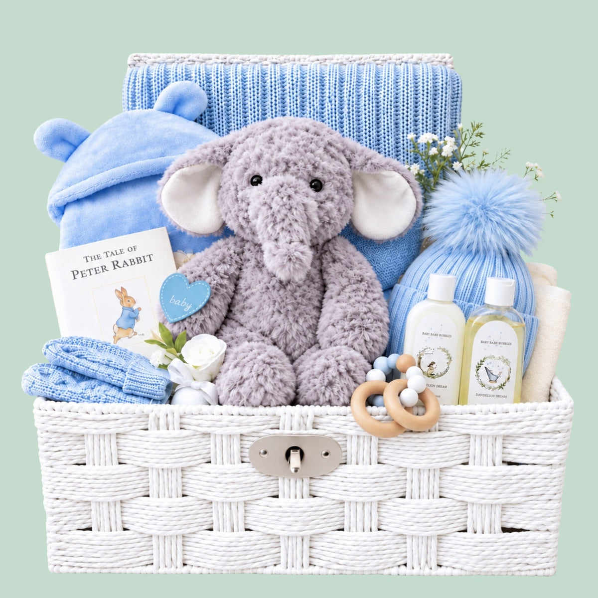 Newborn baby boy hamper basket with gifts including blue and grey presents such as a blanket, dressing gown and elephant soft toy