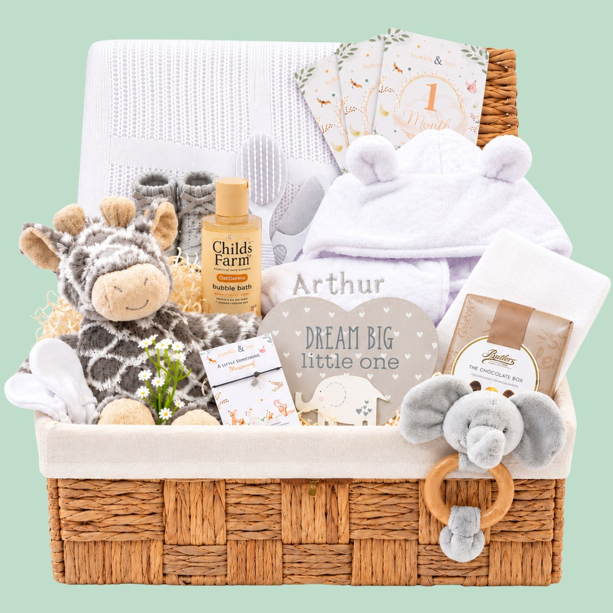 New baby gifts in a hamper basket with giraffe soft toy, baby bath robe and chocolates