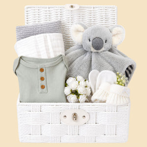 New baby gifts basket with white and grey presents. This baby hamper includes soft koala comforter toy and baby essentials. Bumbles and Boo.