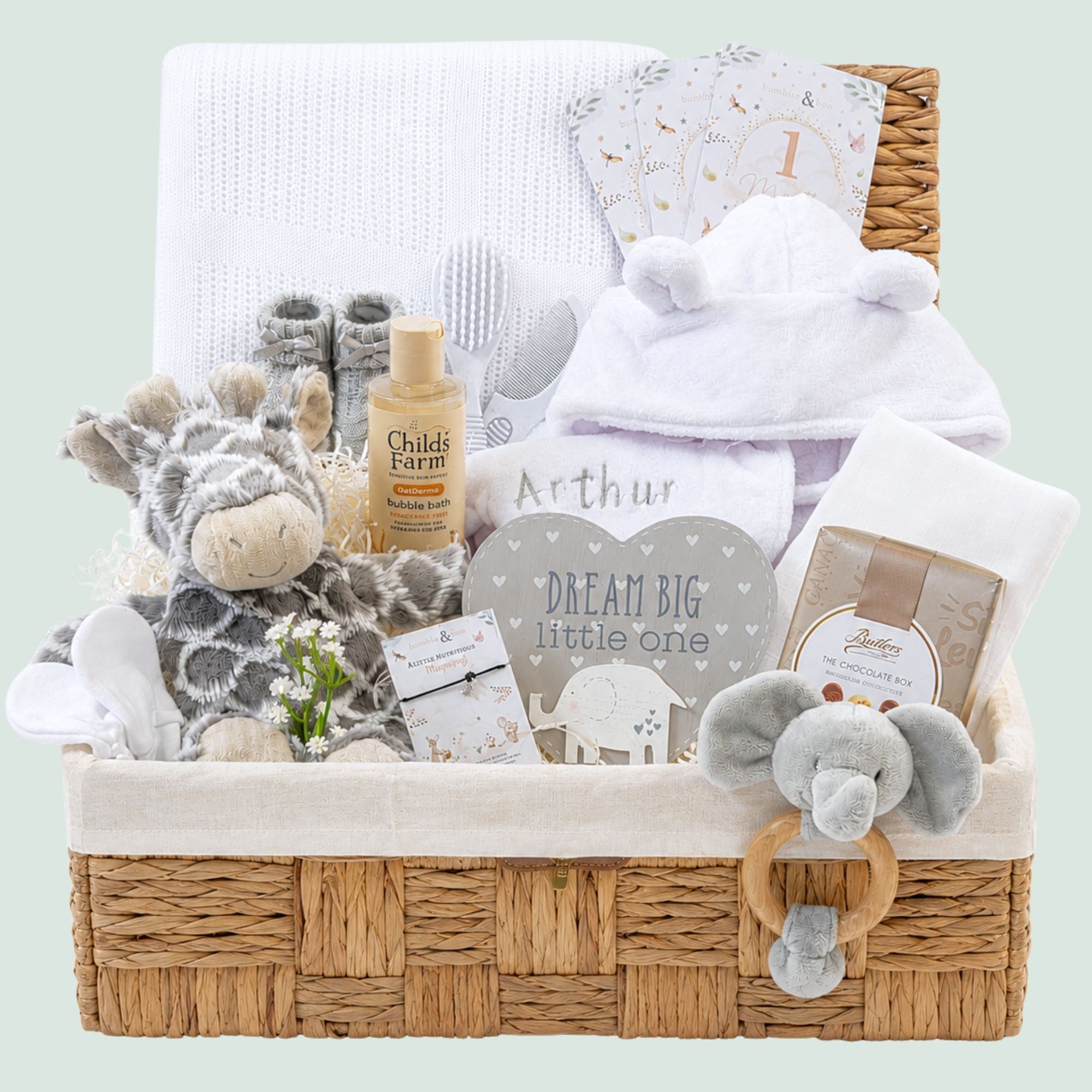 New baby gifts in a hamper basket with giraffe soft toy, baby bath robe and chocolates