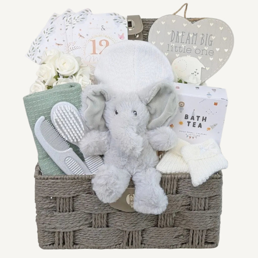 White and green new baby gifts in a hamper basket. Bumbles and Boo. 