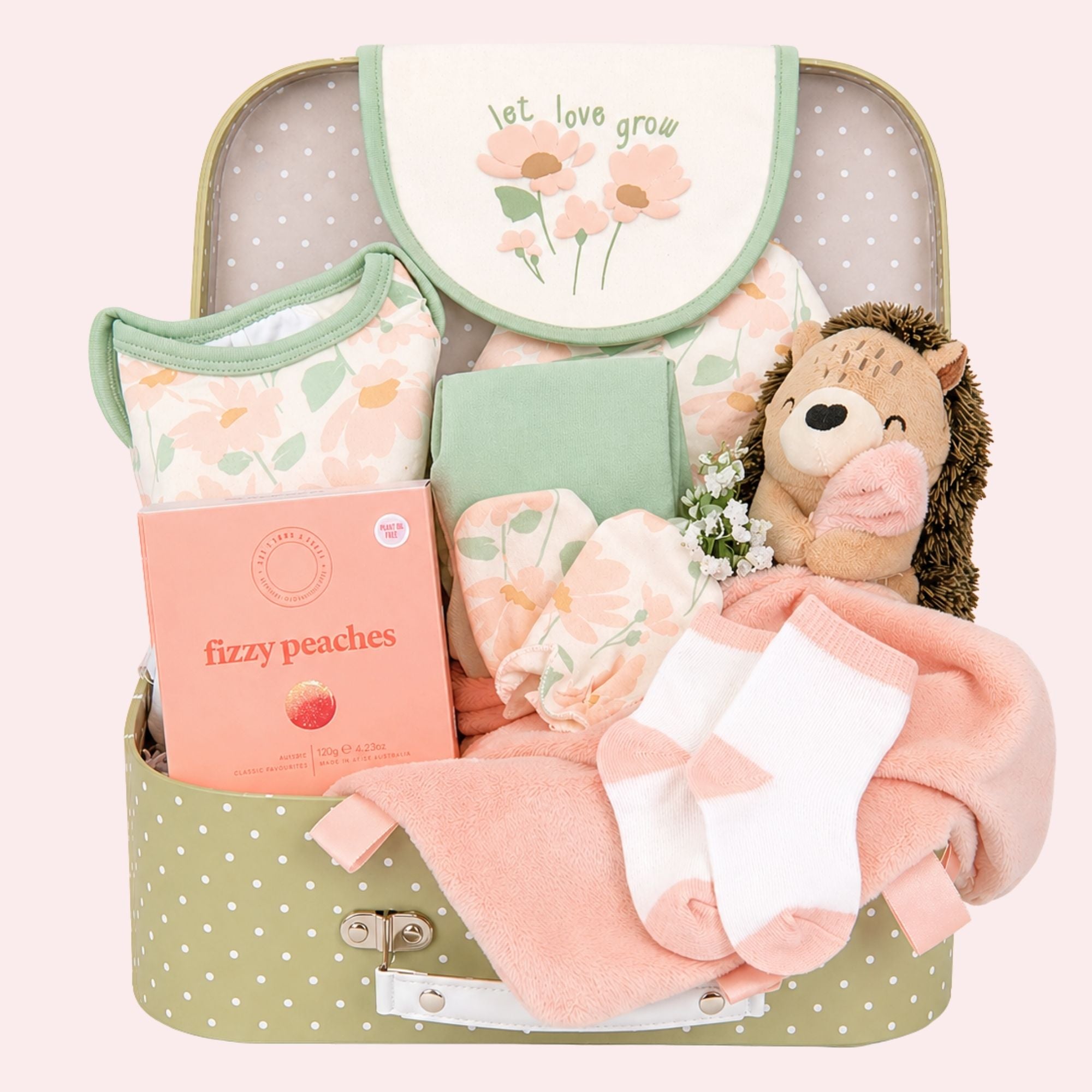 new baby girl hamper gifts to include clothing set in green and peach and hedgehog soft toy