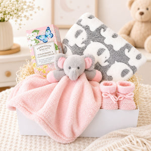 Hamper gifts for a baby girl in a white magnetic box with elephant comforter and elephant blanket