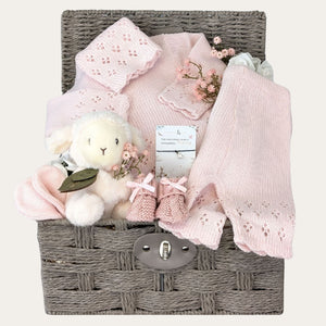 New baby girl gifts hamper basket with pink knit clothes set. Presents include lamb soft toy and a bracelet for mum by Bumbles and Boo.