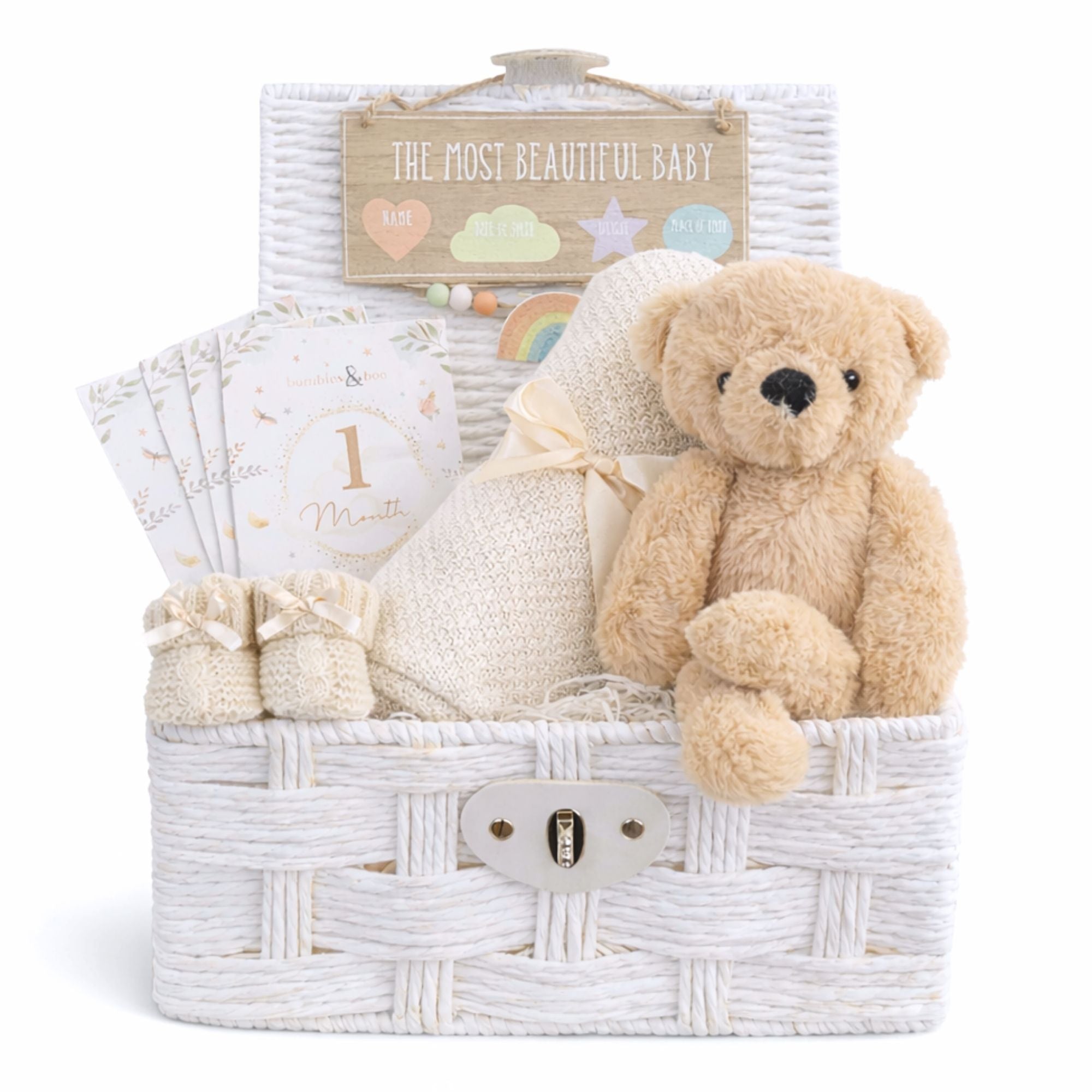 New baby hamper with a teddy bear and blanket in a white basket.