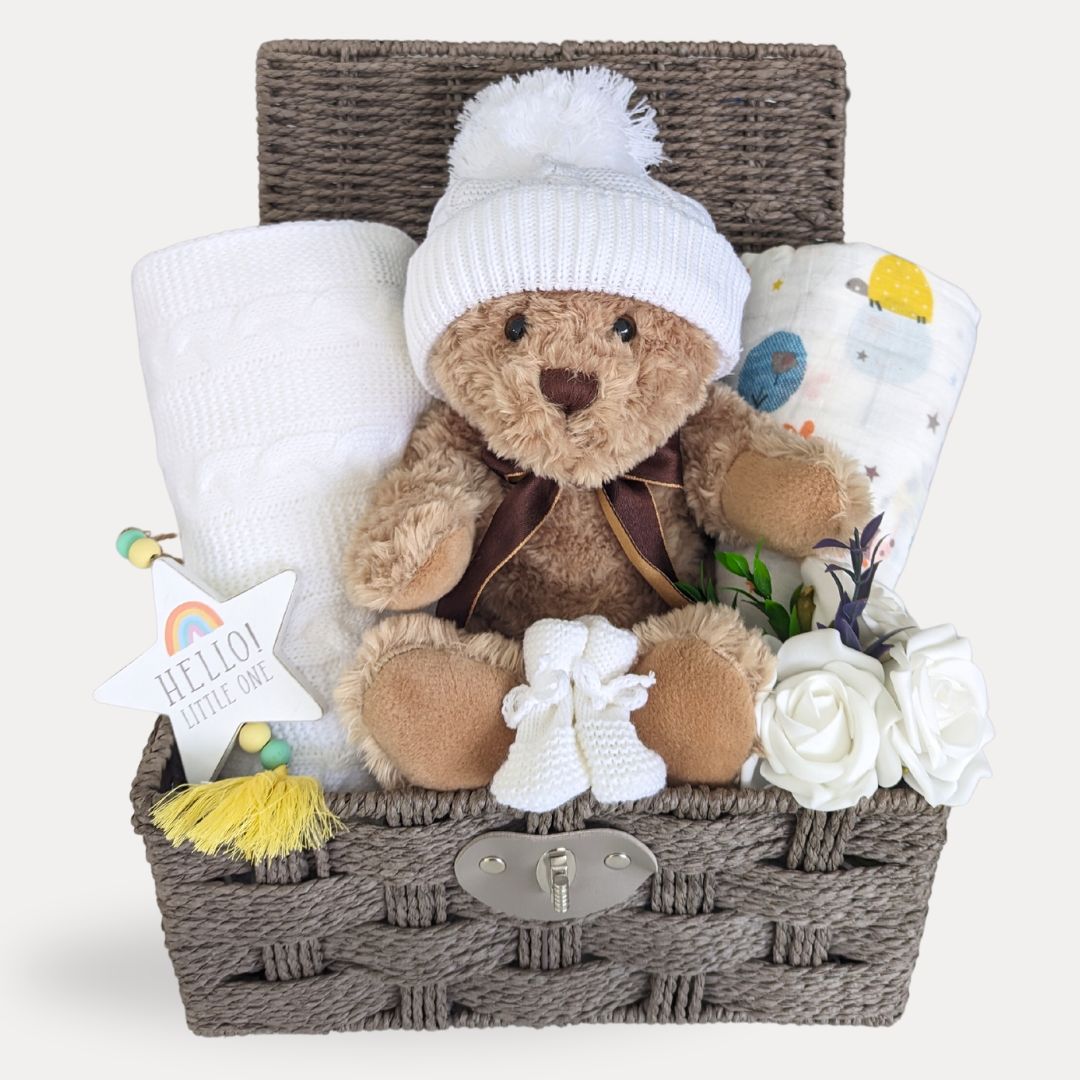 New baby hamper basket with teddy bear in white hat