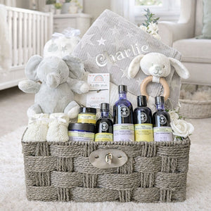 Presents for a new mother which include neals yard skincare and personalised baby blanket.