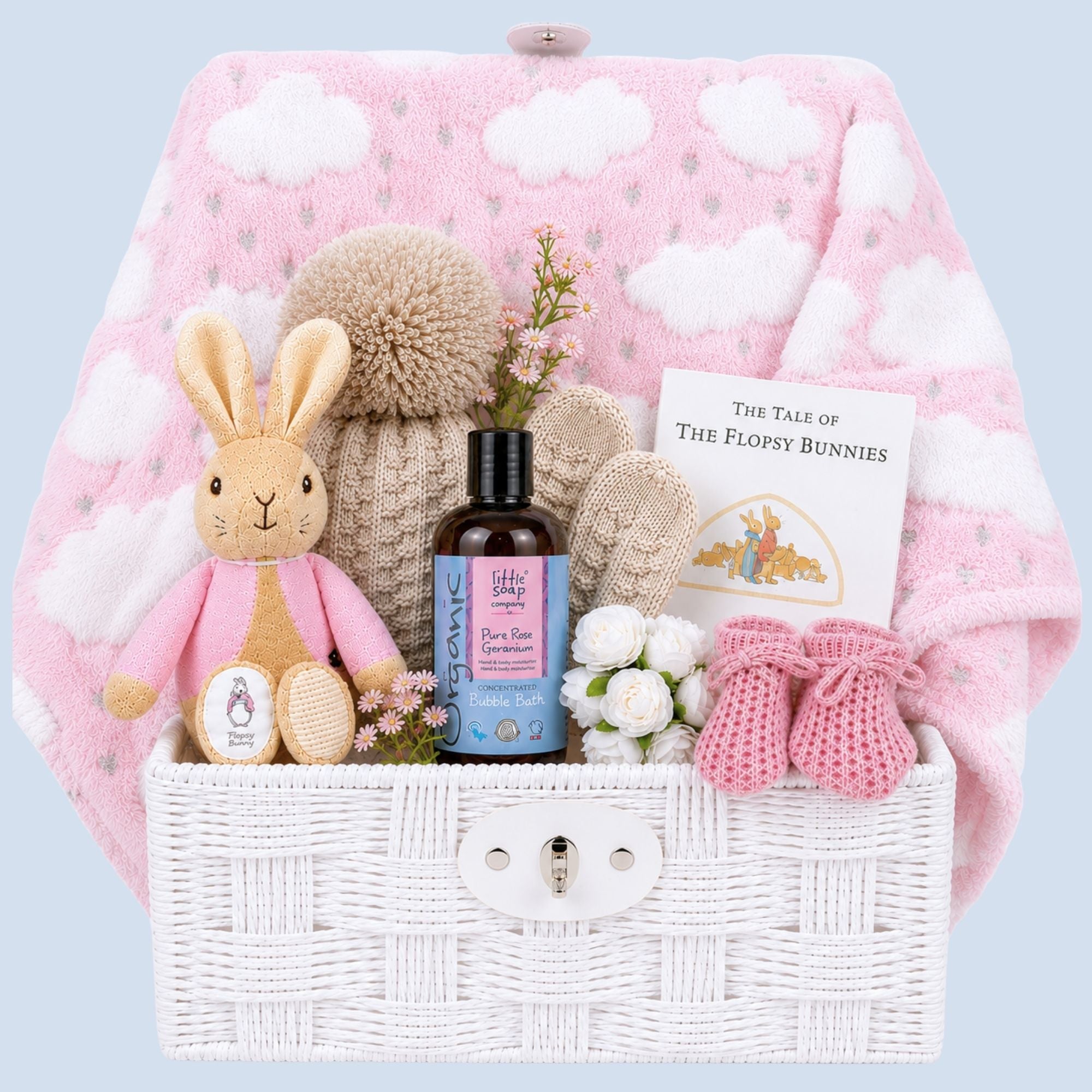 Gifts for a new mum packed in a white hamper basket by Bumbles and Boo.