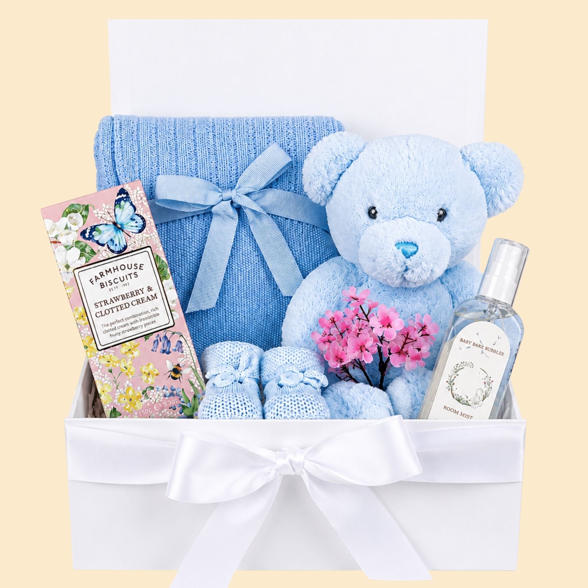 Gifts for new mum which include strawberry biscuits, personalised baby blanket and teddy bear.