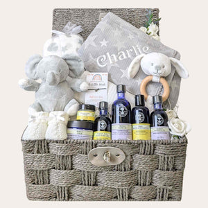 New mum gifts hamper basket with a grey personalised baby blanket and organic skincare. Bumbles and Boo.