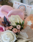 new mum gifts bouquet which includes mittens, socks and bandana bibs.