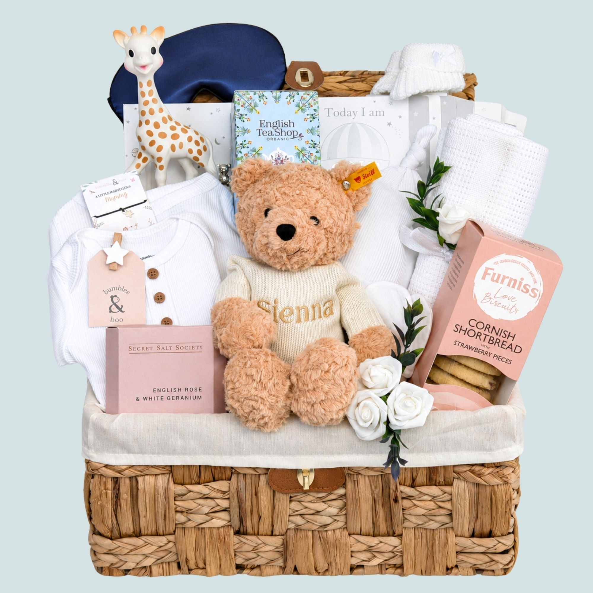 Luxury new mum hamper basket with gifts including biscuits, teddy and pink & white presents. Bumbles and Boo.