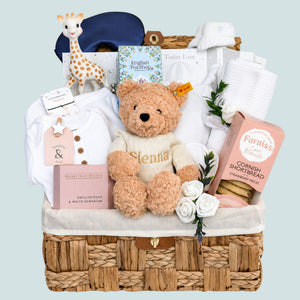 Luxury new mum hamper basket with gifts including biscuits, teddy and pink & white presents. Bumbles and Boo.