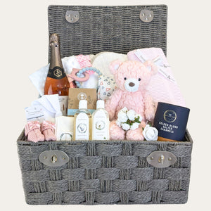 New mum gifts basket with presents including food, drink, skincare and baby items in a hamper by Bumbles and Boo.