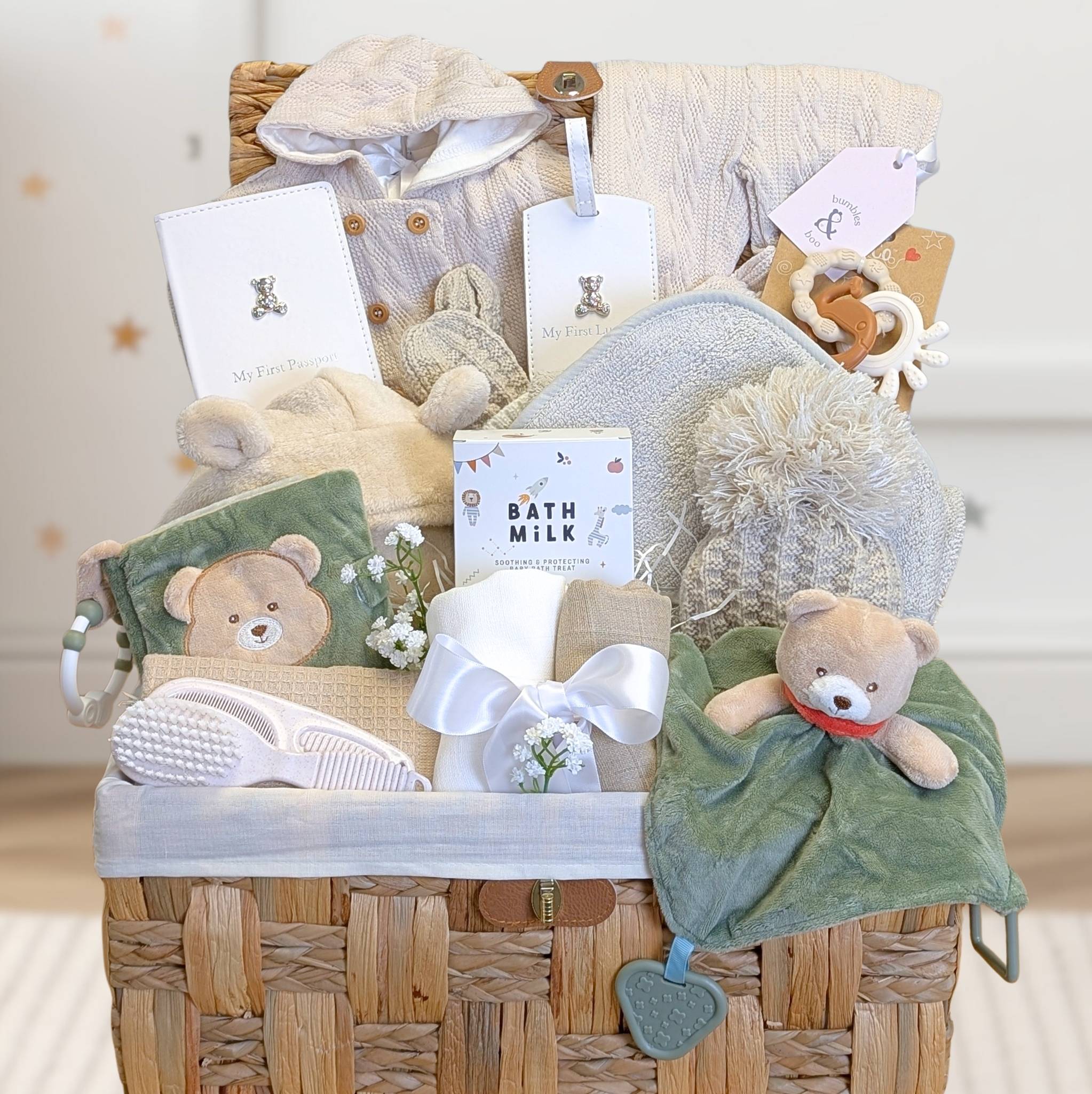Newborn baby presents in a hamper basket with teddy bears theme, this large gift includes cream, beige and green presents for a new baby.