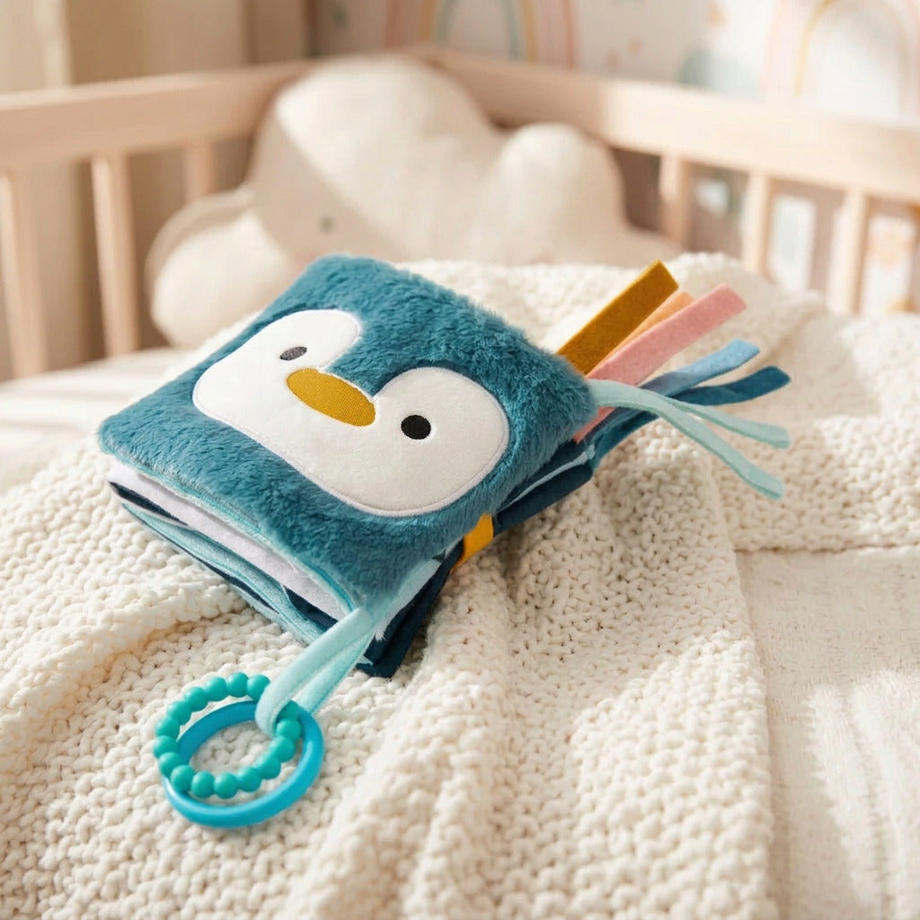Little Big Friends Ocean soft activity book folded closed, showing its penguin cover and two teething rings