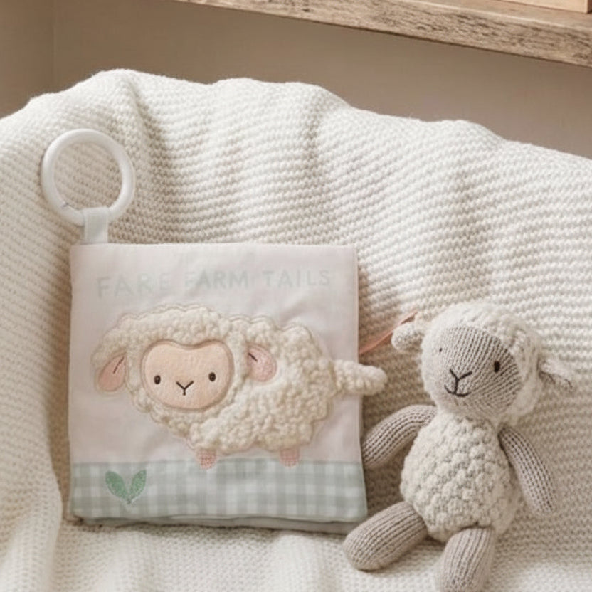 On The Farm soft crinkle baby book displayed with a plush lamb toy