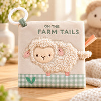On The Farm soft baby book with a textured lamb cover, green gingham trim and white attachment ring.