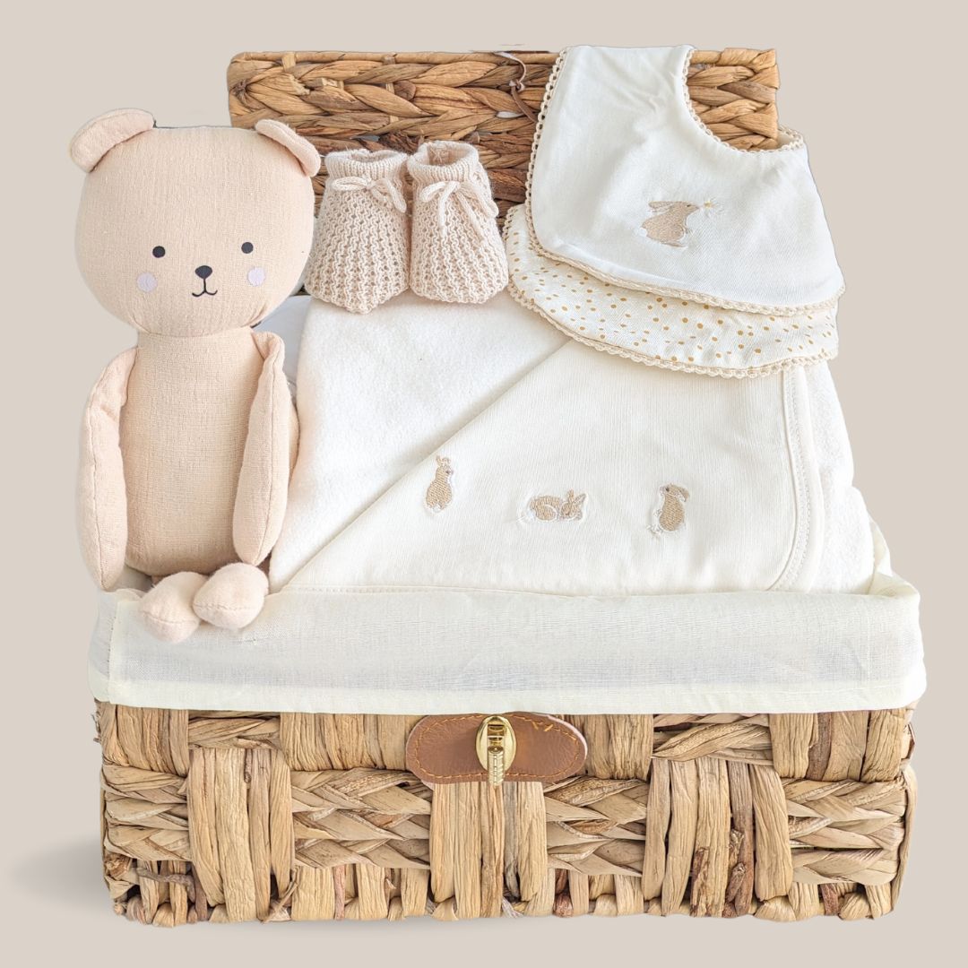 baby hamper basket with organic towel, organic baby bibs and teddy.
