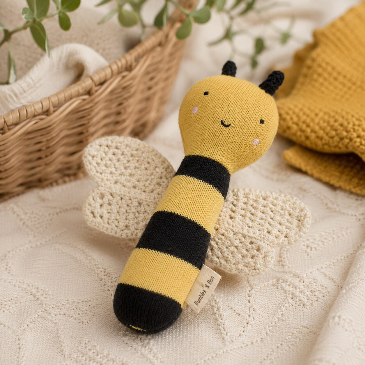 Organic cotton bumble bee baby rattle with knitted wings in yellow and black
