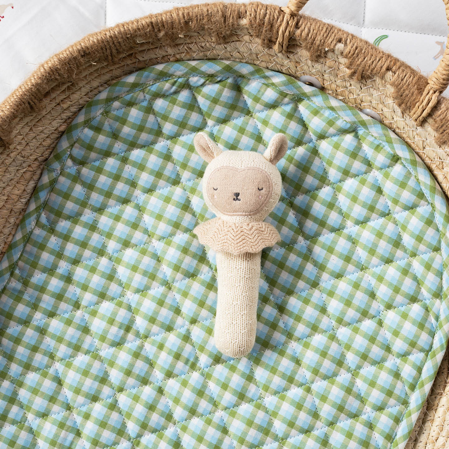 Organic cotton Sleepy Sheep stick rattle baby toy with knitted texture and soft cream finish, designed for little hands to hold and shake.