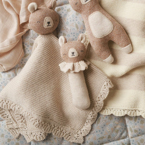 Organic baby comforter toy with a brown bear head and attached blanket, shown with similar toys in the range