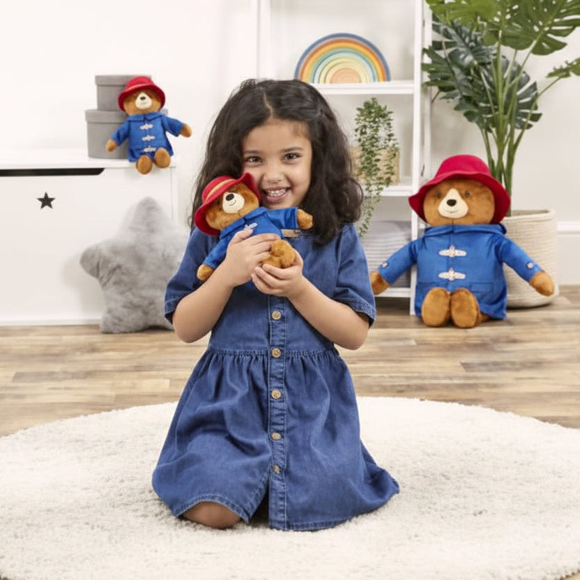 Paddington bear plush toy wearing blue duffle coat and red hat, soft cuddly baby toy for play and comfort