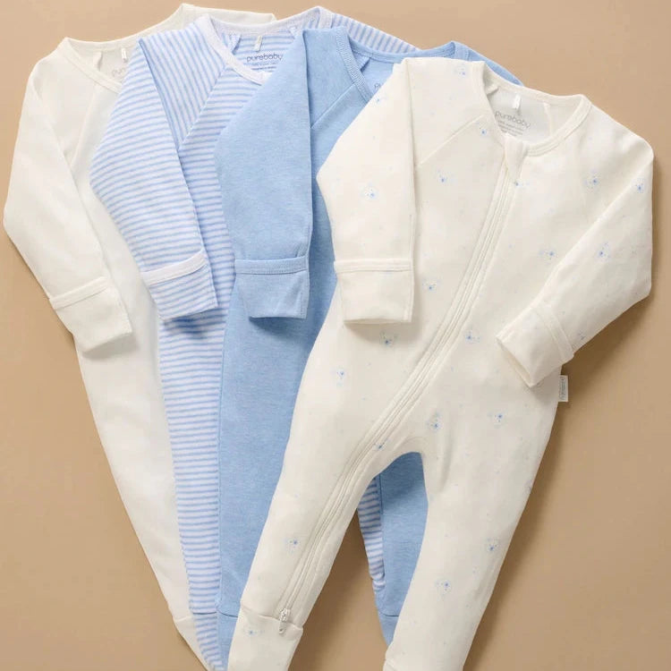 Four pale blue and white baby sleepsuits including a Bear print design