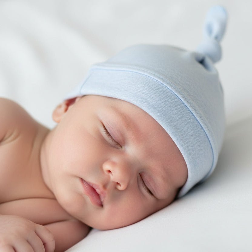 Pale blue melange newborn baby knot hat in soft organic cotton with adjustable top knot and fold-over band