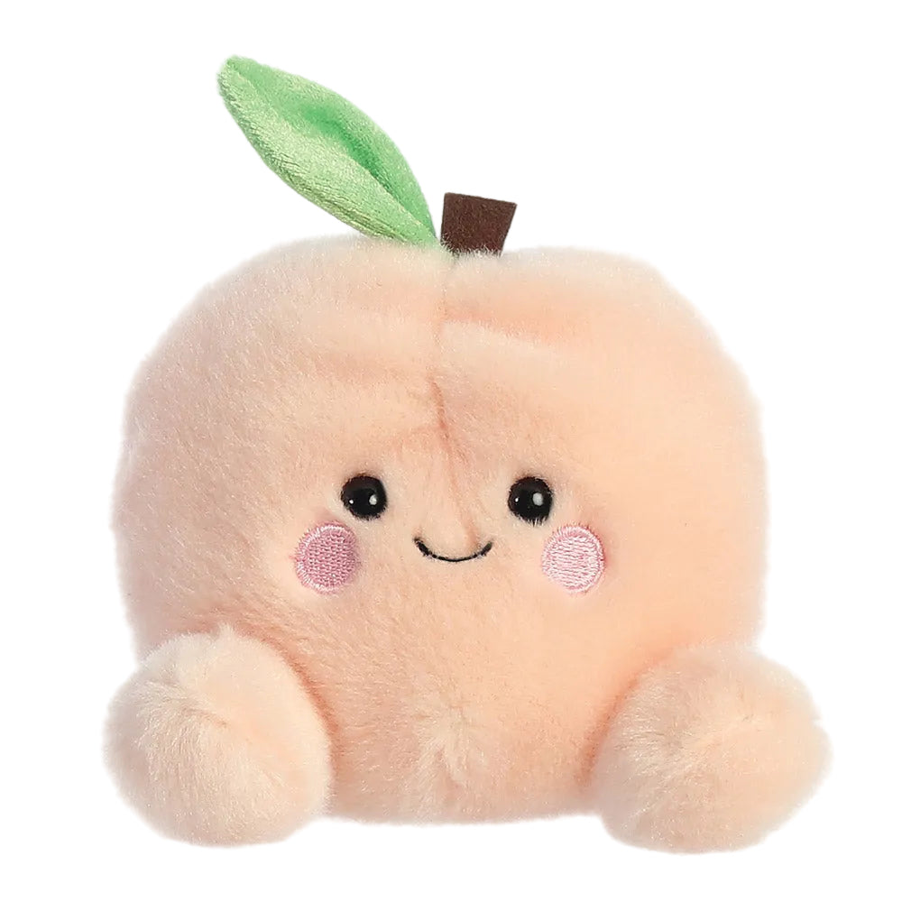 Palm Pals Mellow Peach soft toy in peach plush with smiling face, 13cm baby toy with bean-filled body suitable from birth.