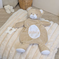 Personalised baby comforter in a beige bear design with a custom name across the tummy and teething toy attached.
