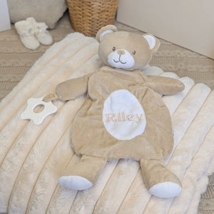 Personalised baby comforter in a beige bear design with a custom name across the tummy and teething toy attached.