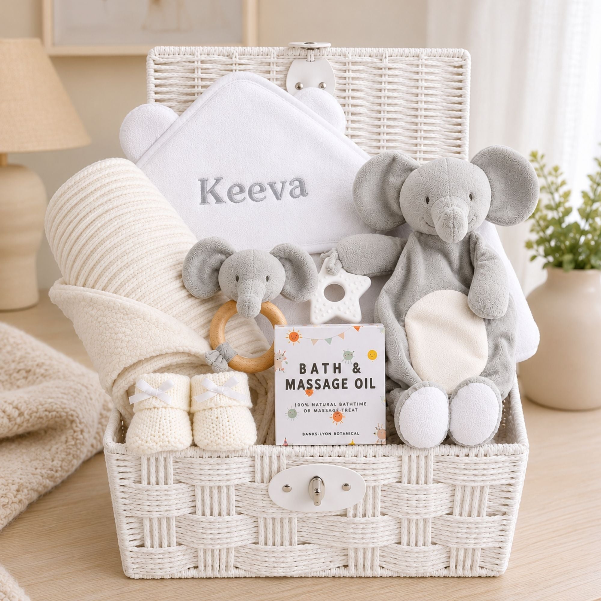 Personalised baby gift hamper basket with elephant comforter soft toy and matching rattle plus bath towel. 