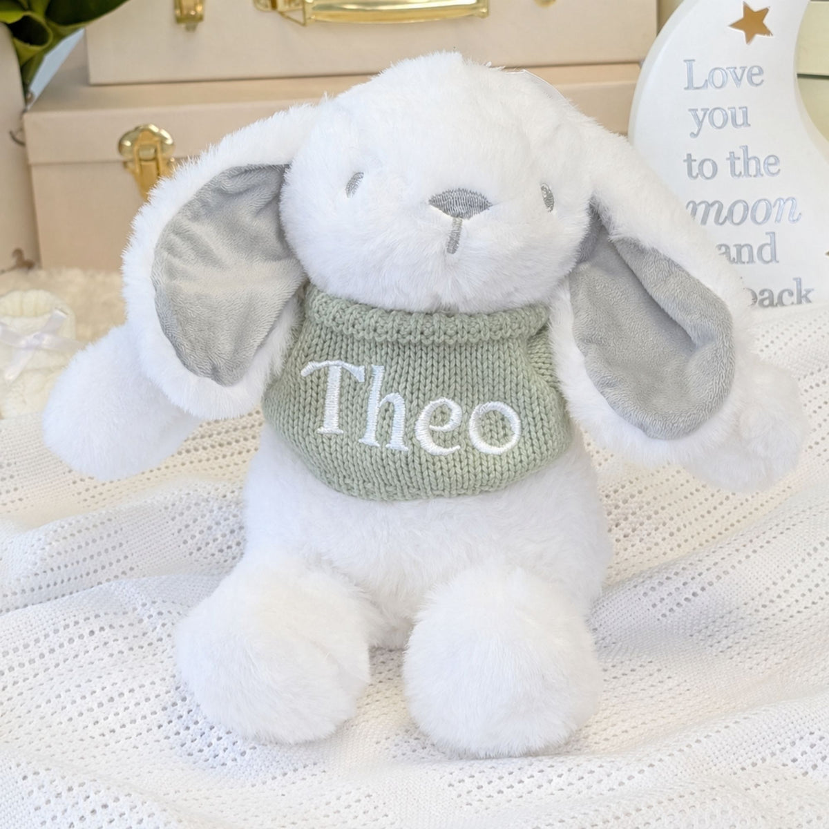 White and grey bunny rabbit with a personalised name on a sage green jumper