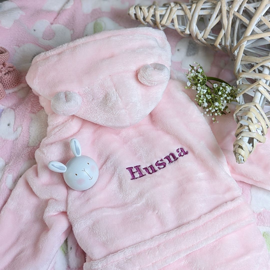Personalised pink dressing gown robe with cute ears - worn by a baby.